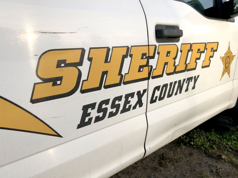 The side of the car with a decal for "Sheriff Essex County" on it.