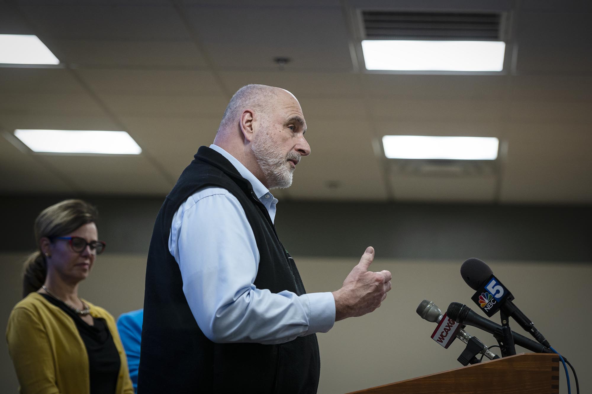 A man standing at a podium with microphones in front of him.
