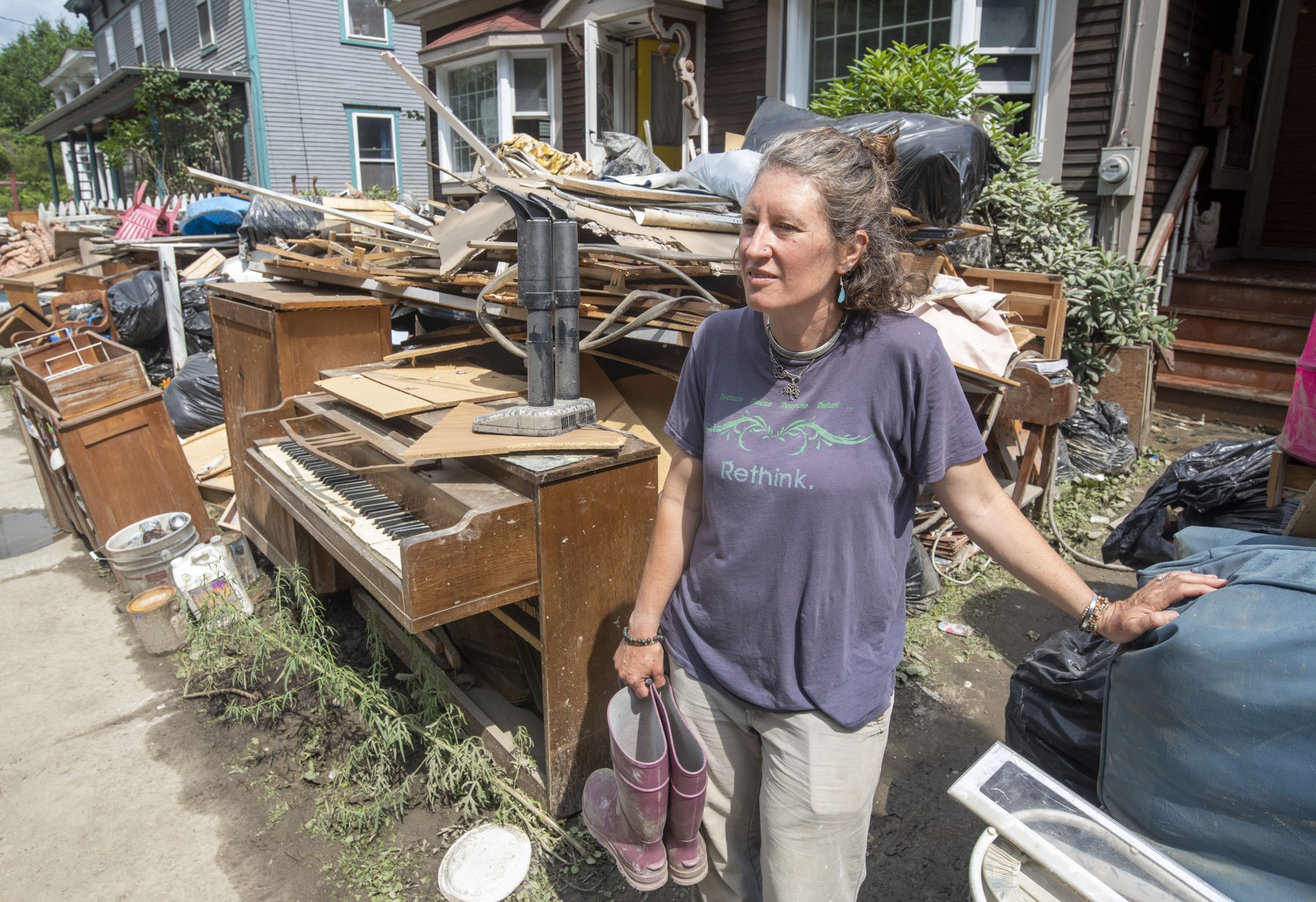 a woman standing in front of a pile of junk.