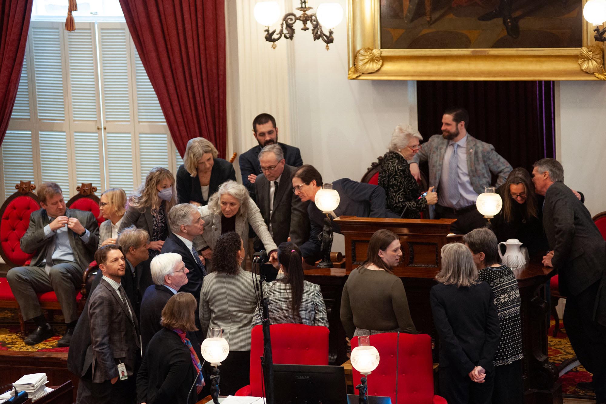People gather around a podium.